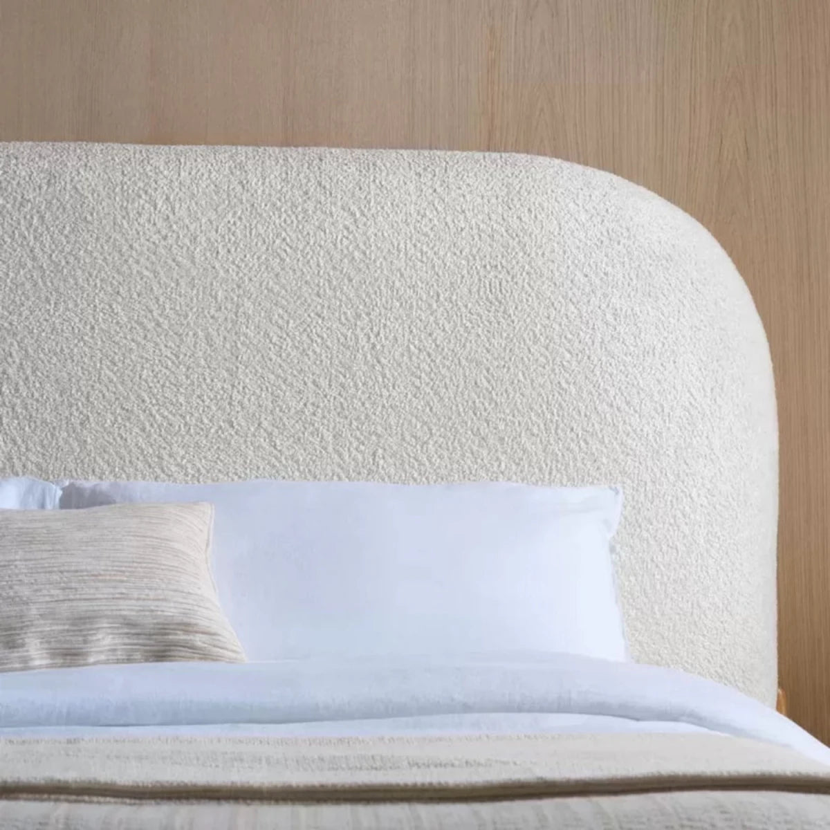 Fabric upholstered headboard with smooth curves and soft padding.