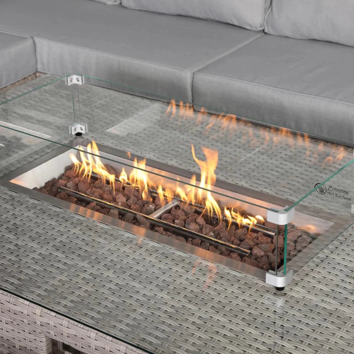 Modern fire table with lift mechanism and warm ambience.