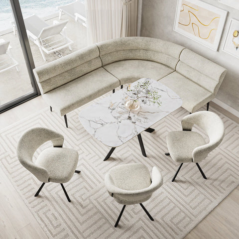 A modern curved sectional sofa dining bench in a light beige bouclé fabric, styled in a bright living room with four matching armchairs, a marble-top coffee table, and a geometric pattern rug.