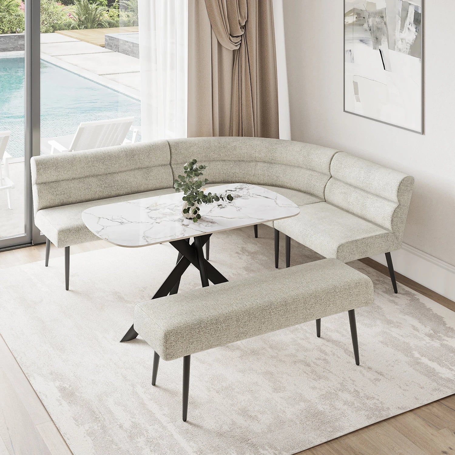 A modern curved upholstered banquette seating set with a matching bench, arranged around a round white marble-top table in a bright dining or lounge area with a window, pool view, and light rug.