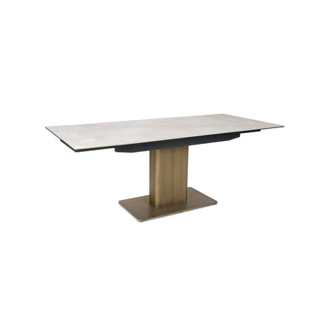 Contemporary white sintered stone dining table with gold pedestal and double extensions
