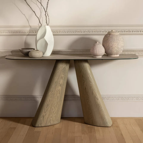 Shop the Arlo Cream Ceramic Console Table with a Spanish ceramic and tempered glass top, sculptural ash wood bases and elegant slim design. W150cm.
