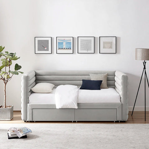 Bellanova Luxe Daybed. Lifestyle image of a light grey velvet upholstered daybed with tufted armrests. 