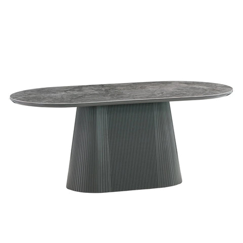 An oval dining table with a textured gray stone-look top and a fluted pedestal base in a matching dark gray finish, shown on a plain white background.