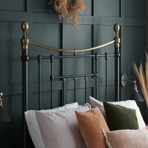 Traditional metal bed with curved headboard.