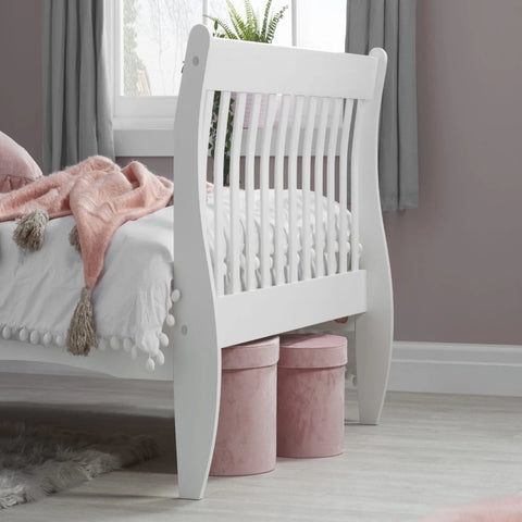 Simple pine bed frame with natural wood finish for modern interiors.