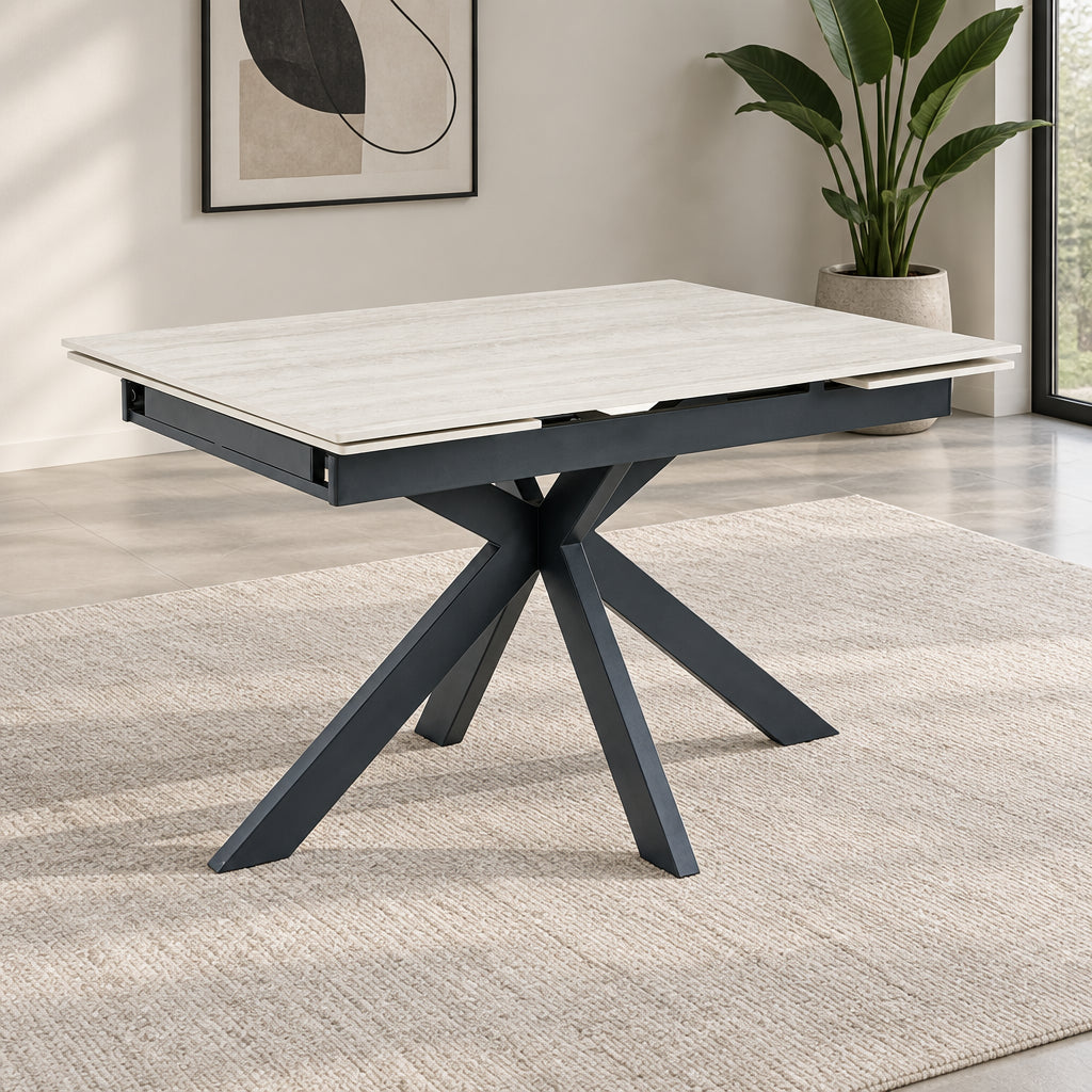 Dining table with Ivory Sintered Stone Ceramic top and dark metal base on a white background