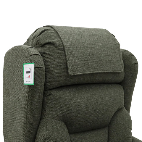 Close-up of a dark olive green upholstered Berkshire Fabric Upholstered Premium Comfort Accessibility Rise & Recline Chair with Quad Motor, backrest with a padded headrest and a small product tag attached to the left armrest, on a white background.