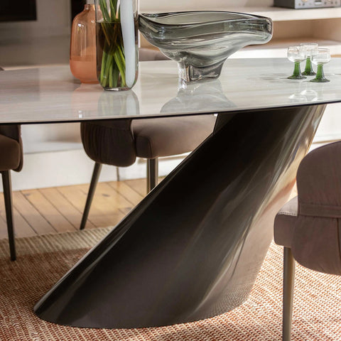 Luxury ceramic dining table with bronze sloped pedestal