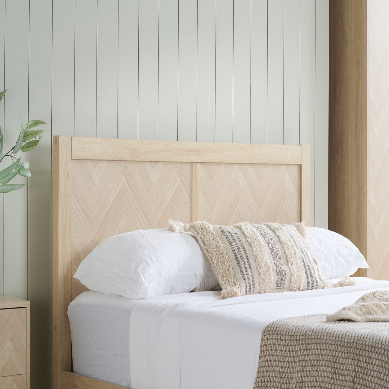 Wood effect headboard with architectural chevron pattern.