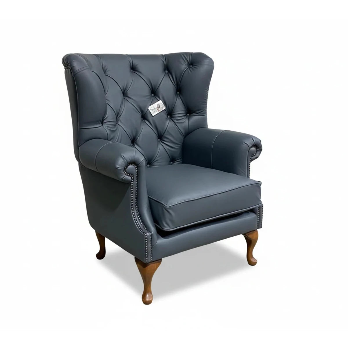 grey leather armchair with wooden legs on a white background