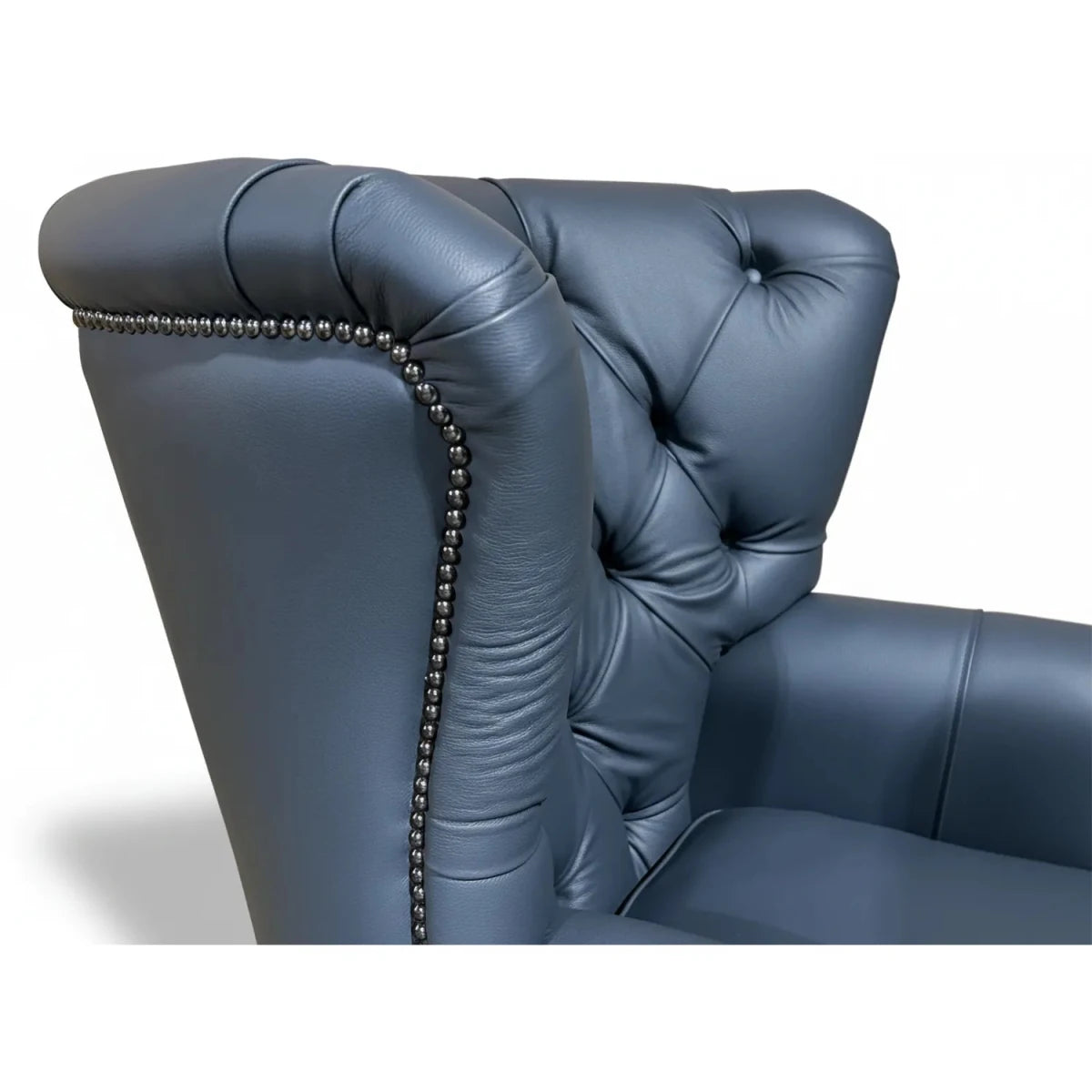 Grey leather armchair with tufted backrest on a white background