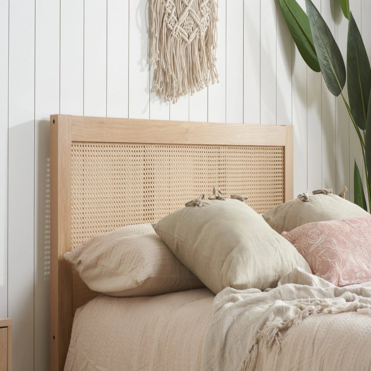 Woven rattan headboard with warm organic texture.