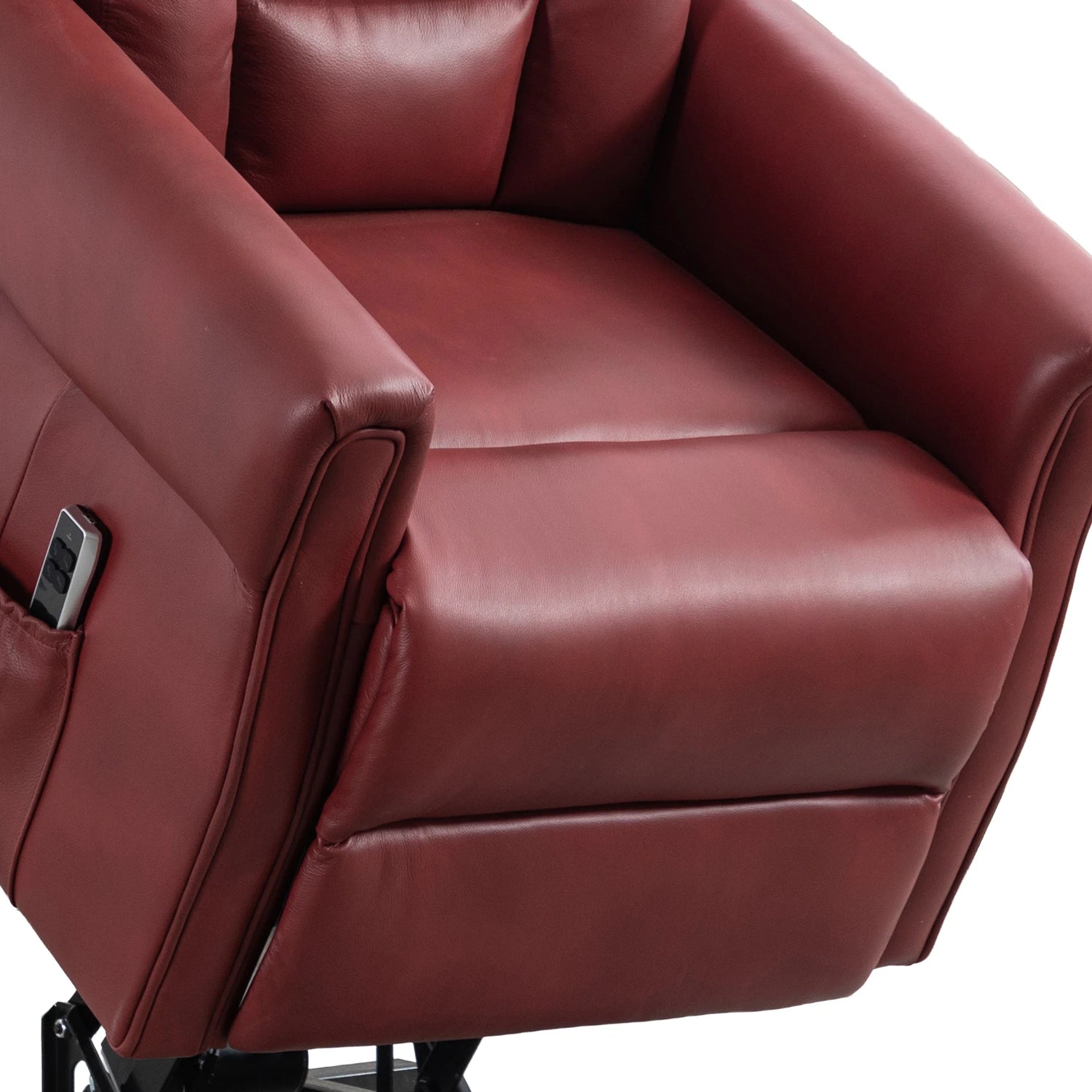 A close-up of a Buckingham Burgundy Full Leather Lift & Tilt Recliner Chair with High Back showing the padded seat, armrest, and side pocket with a remote control, isolated on a white background.