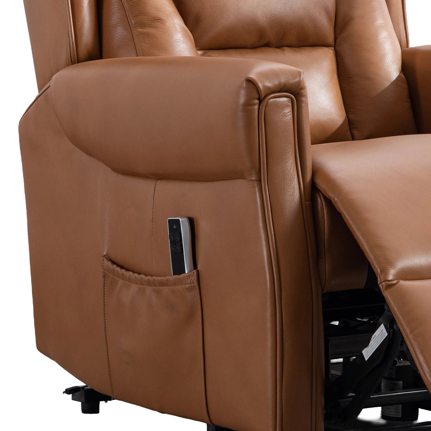 Close-up of a Buckingham Camel Full Leather Lift & Tilt Recliner showing the side pocket with a remote control inside, the extended footrest, and the black support mechanism underneath, on a white background.