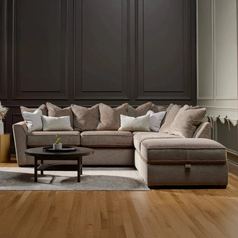 Luxury Buoyant Caspian Marlon taupe corner sofa with plush scatter cushions and sleek dark wood feet.