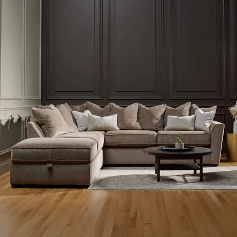 Luxury taupe left-hand corner sofa with plush scatter cushions and sleek dark wood feet.