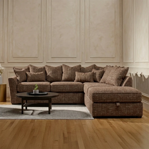Luxury Buoyant Caspian Marlon chocolate brown corner sofa with plush scatter cushions and sleek dark wood feet.