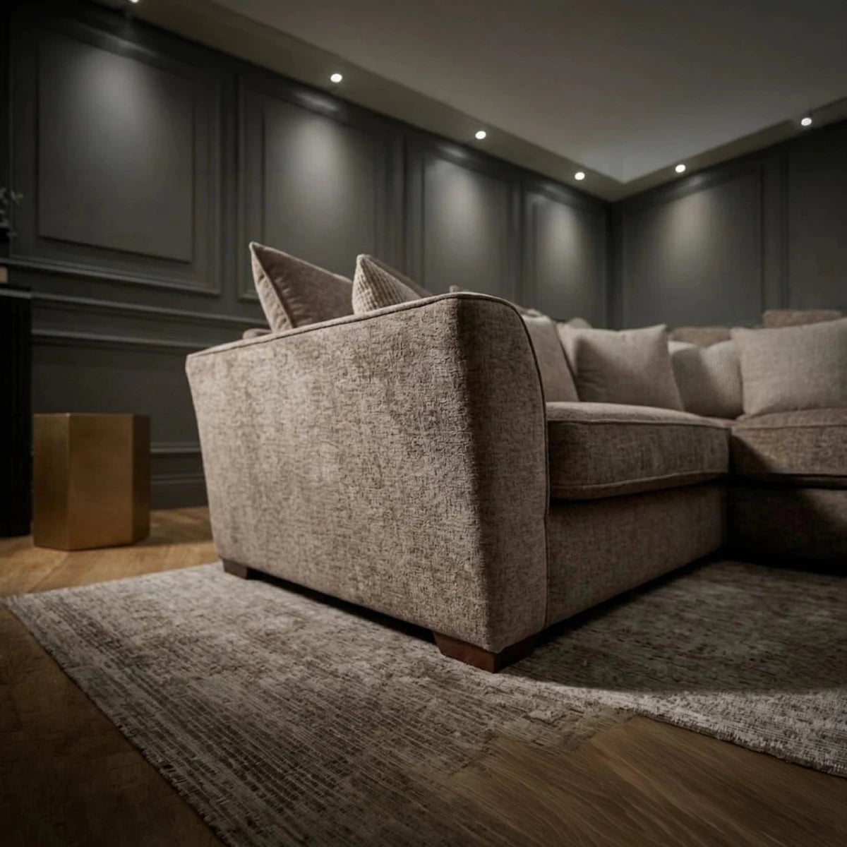 Close-up of Buoyant Caspian Marlon taupe textured fabric and sleek dark wood feet.
