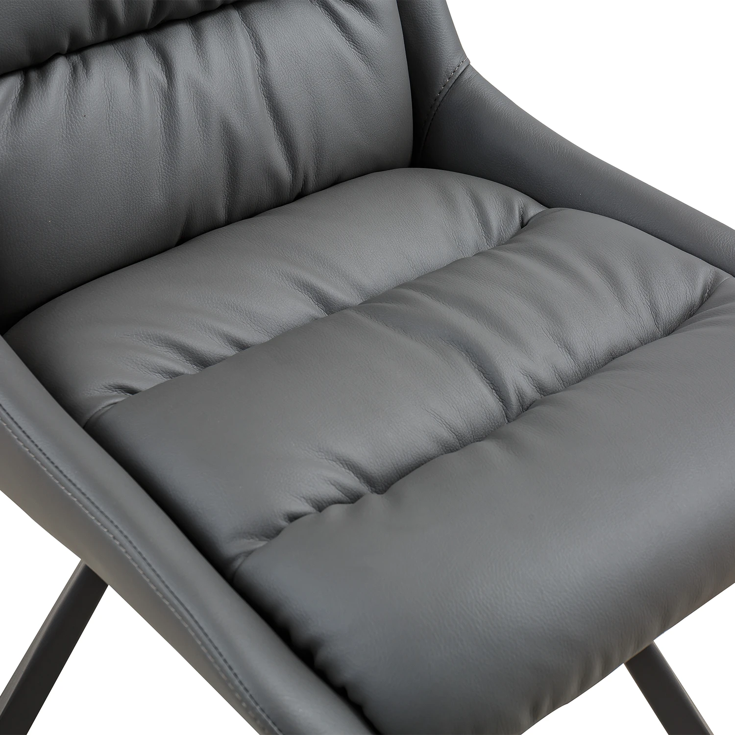 Close-up of a dark gray upholstered chair seat with padded tufted sections and smooth leather-like material, shown against a white background.