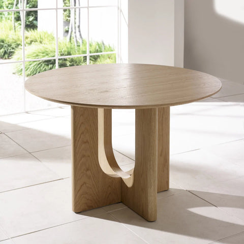 Shop the Cove 120cm Natural Oak Effect Round Dining Table. Seats 4, with a sculptural intersecting pedestal base and beautiful natural wood grain finish.