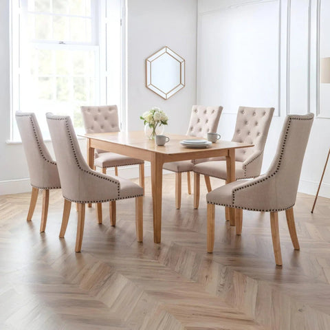 Shop the Cotswold Oak Extending Dining Table with 4 or 6 Loire Oatmeal Linen Button Back Chairs. Elegant upholstered seating and a 140-180cm oak table.