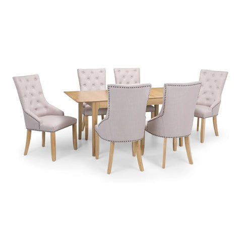 Dining table set with six upholstered chairs on a white background