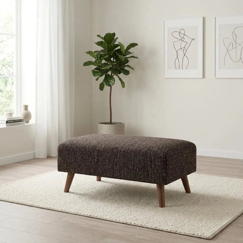 Modern footstool with soft upholstery and elegant finish.