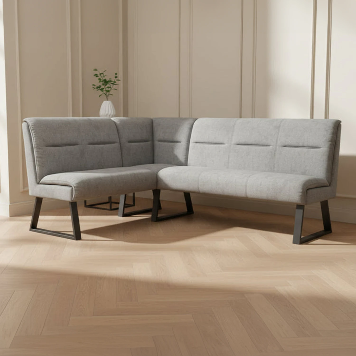 alt="Grey fabric L-shaped corner dining bench with padded backrest and grey powder coated legs in a modern dining room"