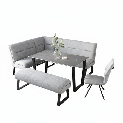 Modern dining set with grey fabric corner bench, grey ceramic dining table, and grey backless bench with white background 