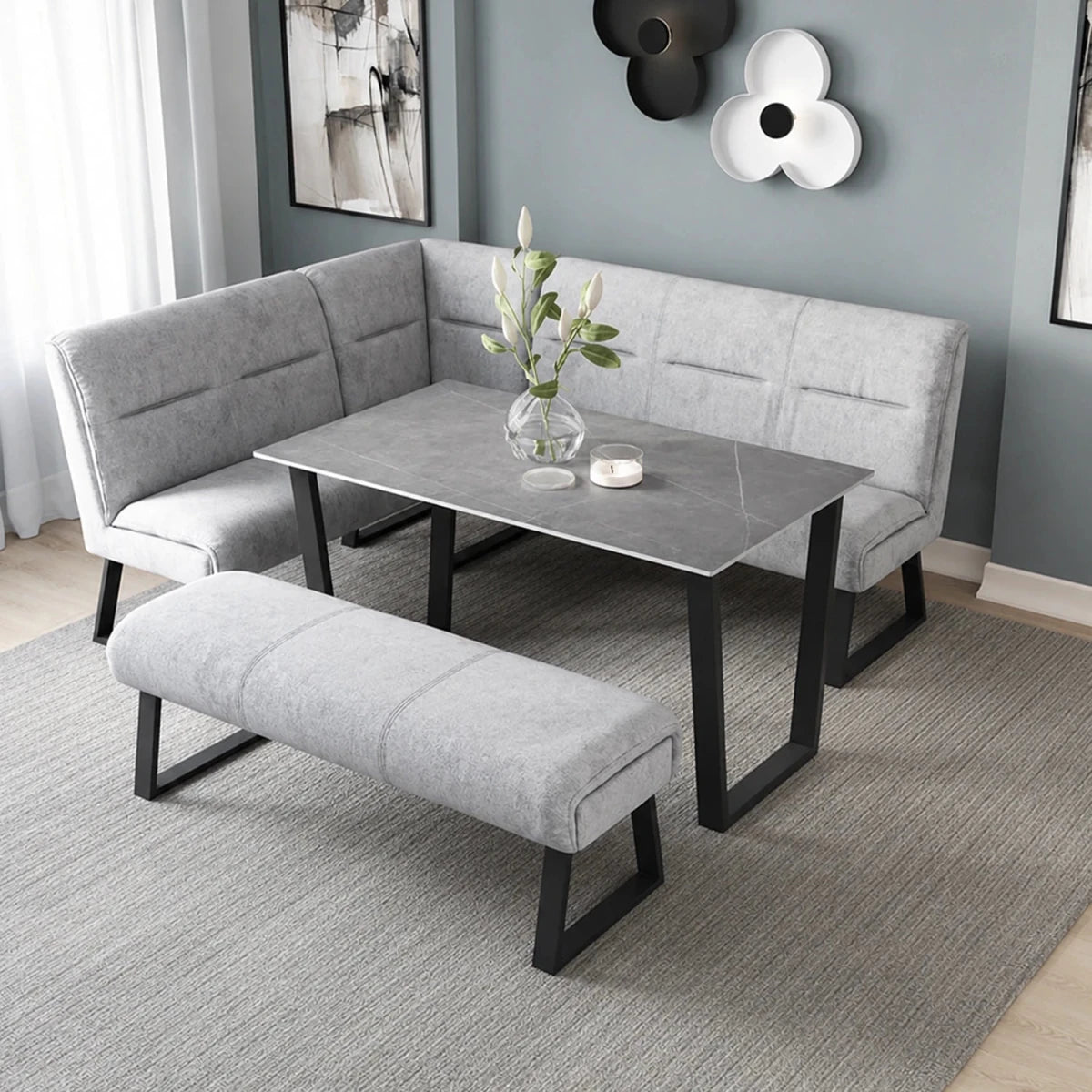 Modern dining area featuring Cerutti grey fabric corner dining bench, backless bench and grey ceramic dining table