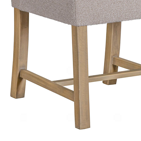Legs close up of Chateau Hing Back Beige upholstered chair with wooden legs on a white background