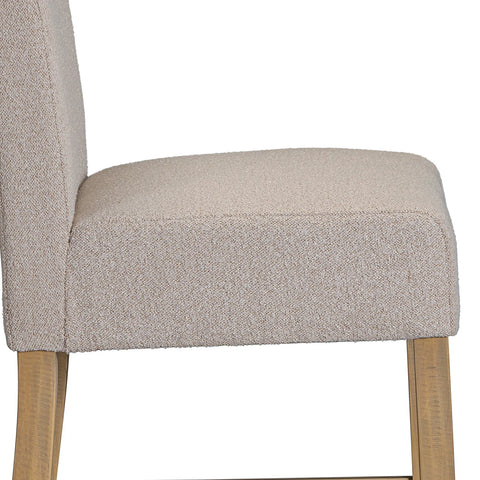 Seat Close up of Chateau Hing Back Beige upholstered chair with wooden legs on a white background