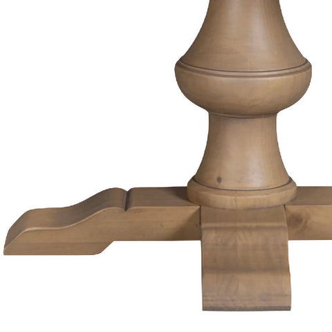 Close-up of a wooden table pedestal base and cross support leg in a light natural oak finish, shown against a plain white background.