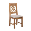 Shop Chatsworth oak dining chairs with decorative cross-back design and beige linen upholstered seats. Crafted from high-grade oak and supplied as a pair.