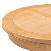Close-up of a round wooden table top with a light oak finish, showing the grain pattern and circular inset detail on a white background.