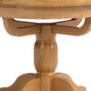 Close-up of a round wooden table pedestal base made of light oak wood with visible grain, isolated on a white background.