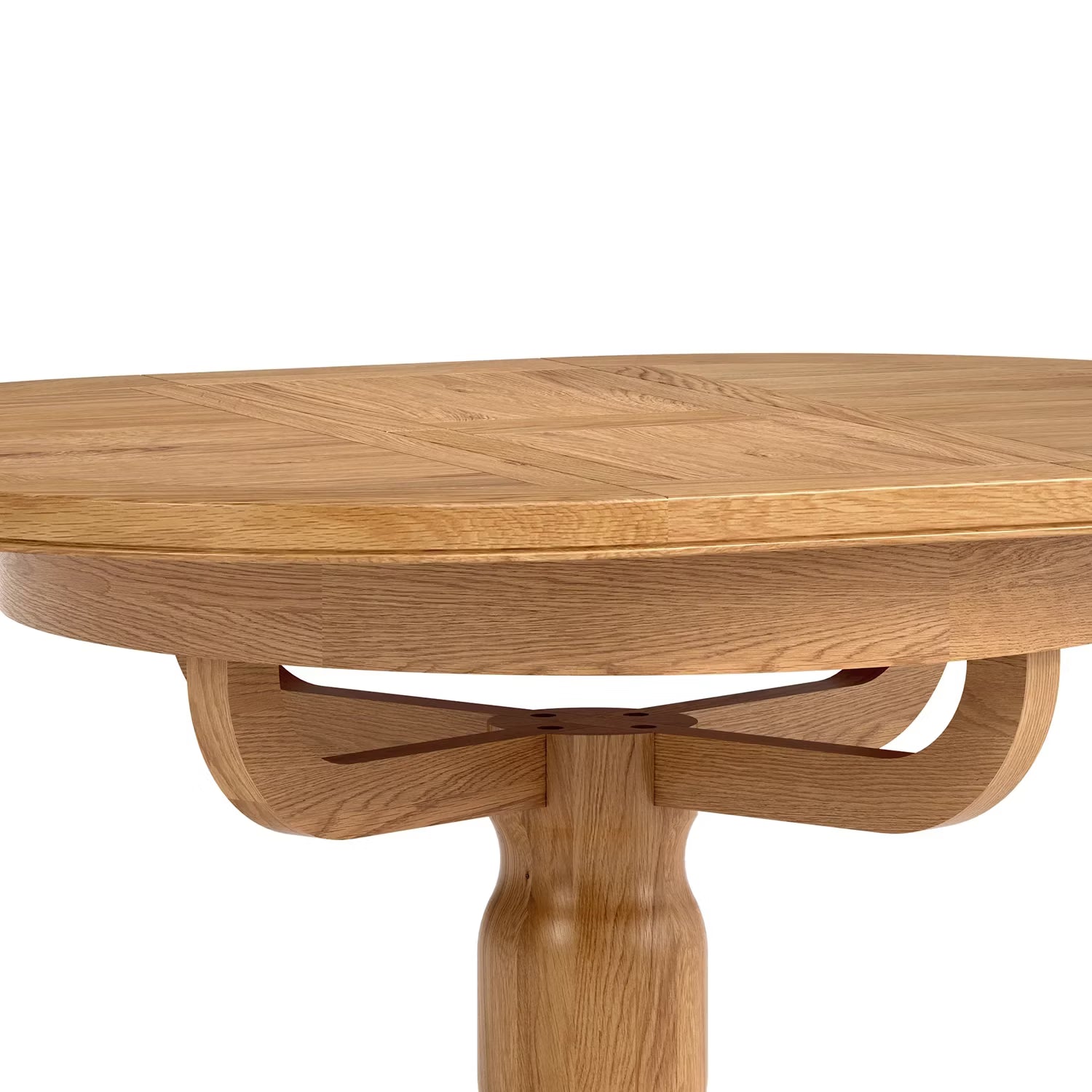 Close-up of a round wooden dining table with a natural oak finish, showing the tabletop grain, a decorative central support, and part of the pedestal leg against a white background.