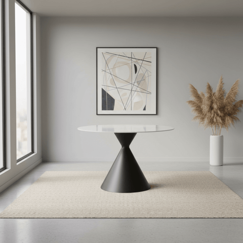 Modern interior with a black and white table, abstract art, and potted plant.