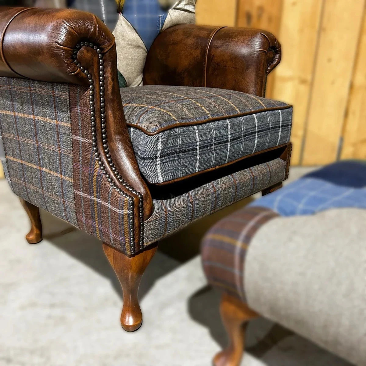 Close up of Cotswold Coloured Patchwork with Antique Tan Leather High Round Back Wing Chair