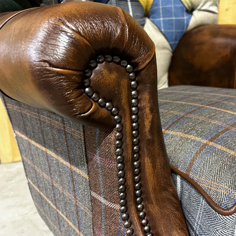 Close up arm of Cotswold Coloured Patchwork with Antique Tan Leather High Round Back Wing Chair