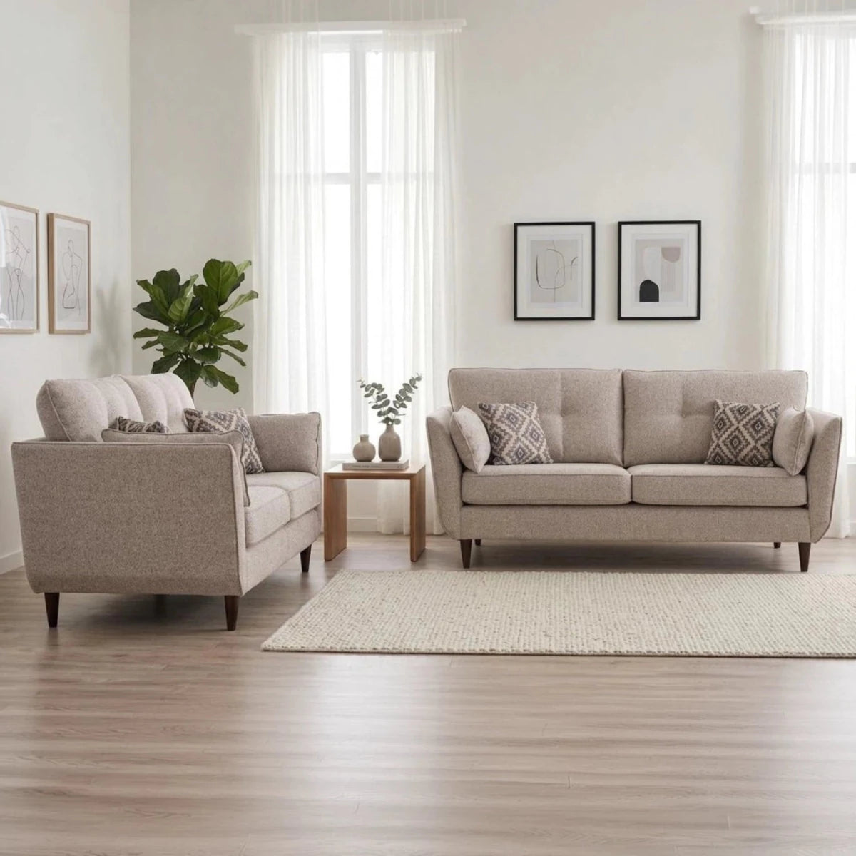 Luxury close-up of 3 and 2 seater sofas with elegant high legs and designer cushions.