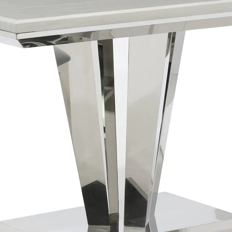 Close-up of a modern table with chrome legs on a white background