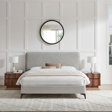 Front View of the Dovira Luxe Bed is a light grey upholstered bed with a tall quilted textured headboard and velvet footend. Available in Grey or Natural fabric and in sizes Double or Kingsize.