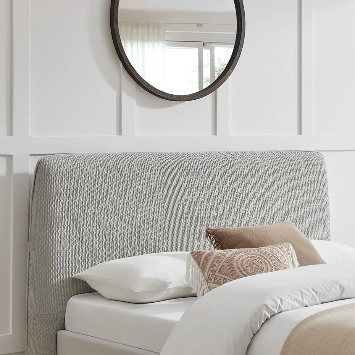 Close up of the rounded edge headboard showing grey textured fabric. Dovira Luxe Bed available in Grey or Natural fabric and in sizes Double or Kingsize. 