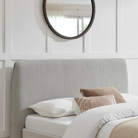 Close up of the rounded edge headboard showing grey textured fabric. Dovira Luxe Bed available in Grey or Natural fabric and in sizes Double or Kingsize. 