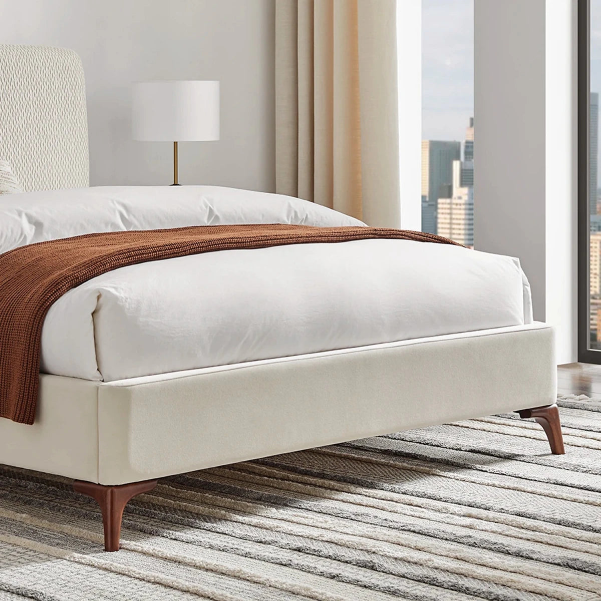 Close up of the velvet footend and walnut feet on the Dovira Luxe Bed. Available in Double or Kingsize.