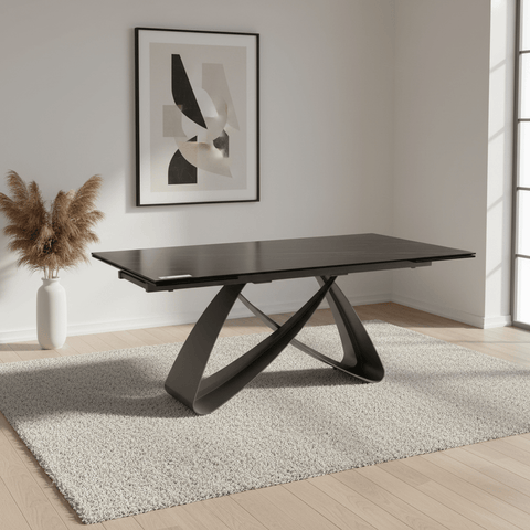 Modern black dining table in a room with abstract art and decor