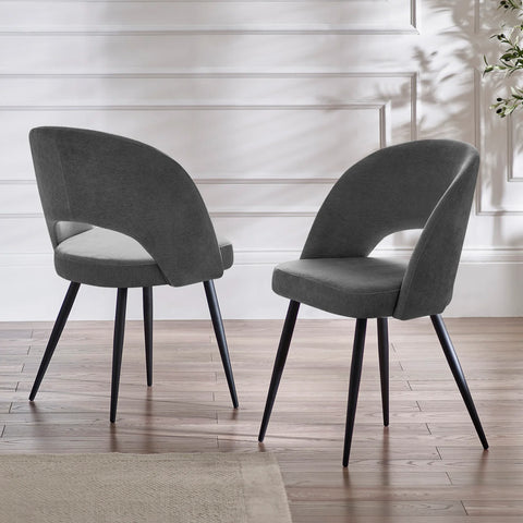 Two gray chairs with black legs on a wooden floor.