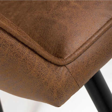 Close up Earth Tan Vintage Leather-Look Carver Dining Chair with black legs